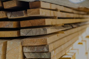 Stacked lumber, backdrop for Yellowstone Lumber page